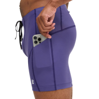 Purple athletic shorts with a pocket holding a phone on a white background